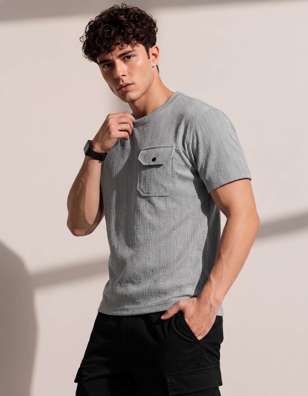 Man wearing a textured gray t-shirt against a plain background