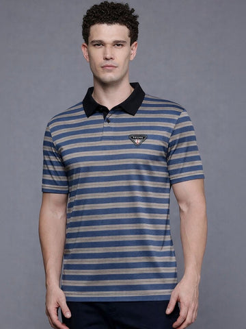 Man wearing a blue and beige striped polo shirt with a brand logo on a gray background