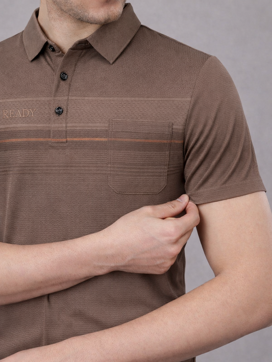 Brown polo shirt worn by a person on a gray background
