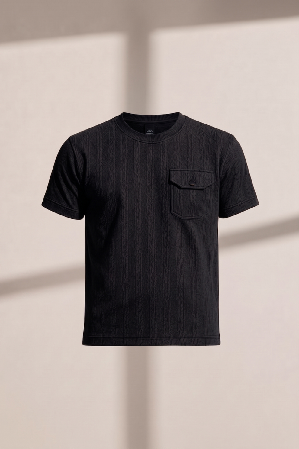 Black t-shirt with a pocket on a beige background
