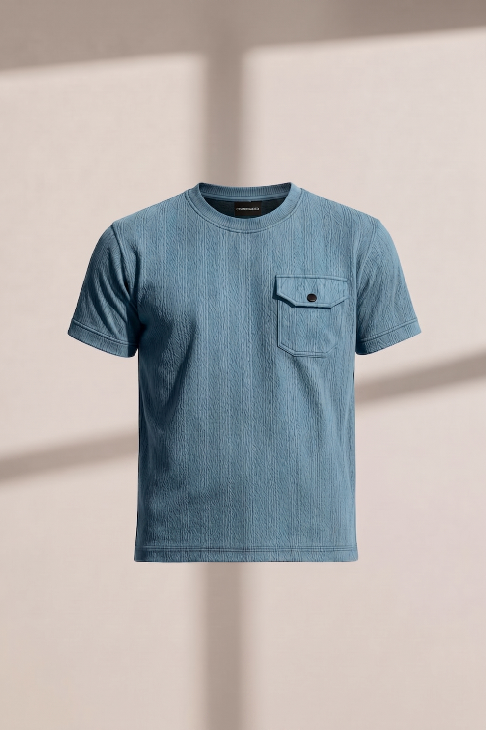 Blue t-shirt with a pocket on a beige background