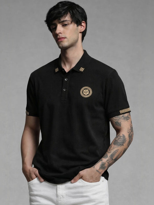 Man wearing a black polo shirt with a logo on a gray background