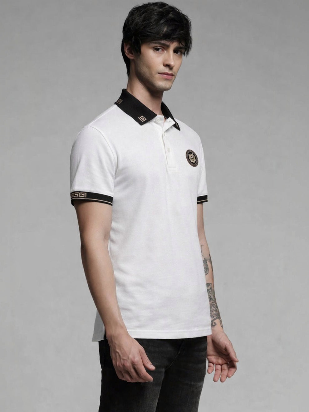 Person wearing a white polo shirt with black accents on a gray background