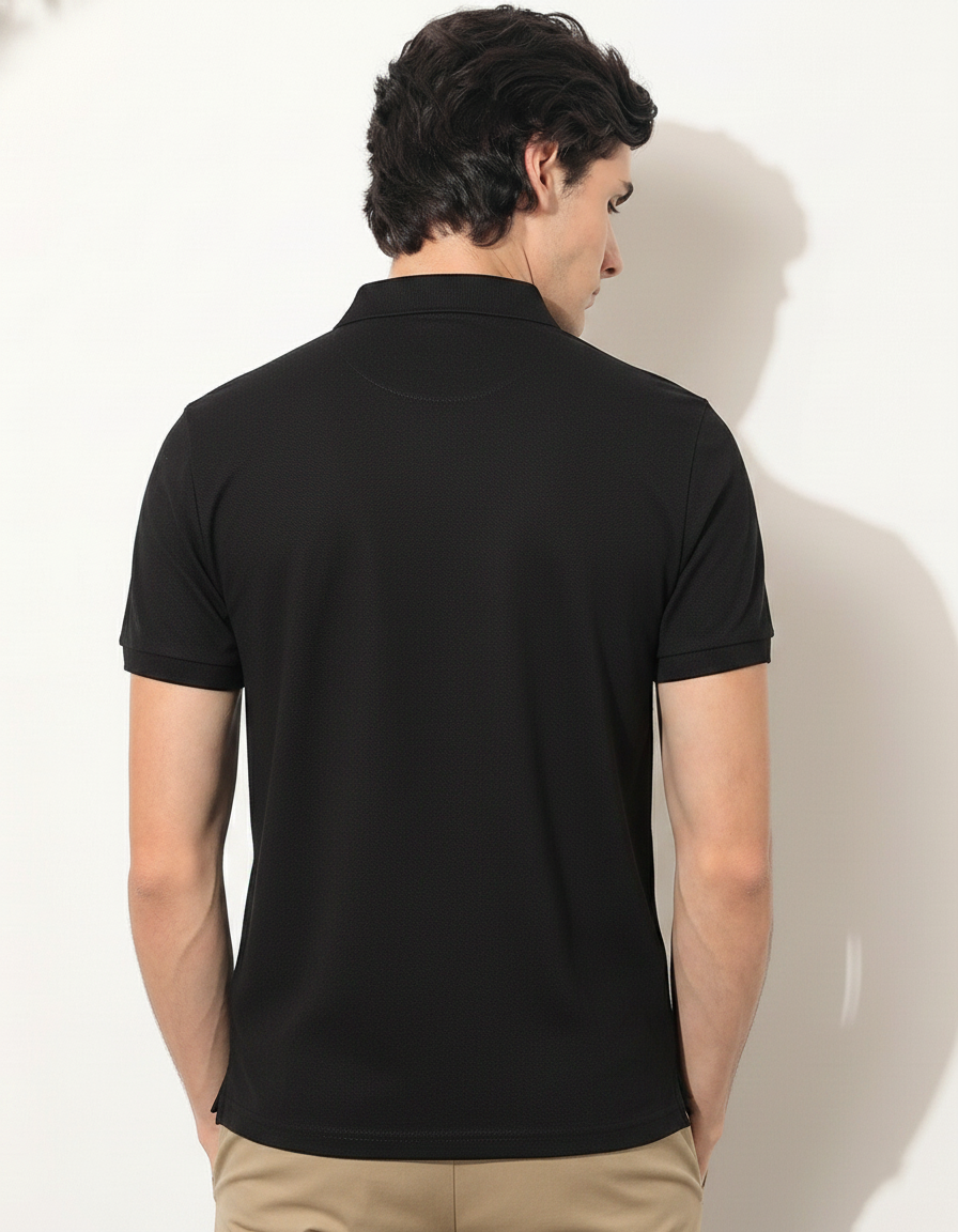 Man wearing a black polo shirt against a white background
