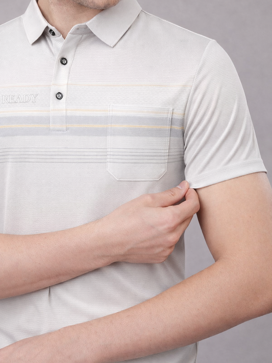 Close-up of a person wearing a light gray polo shirt with subtle striped pattern on a plain background
