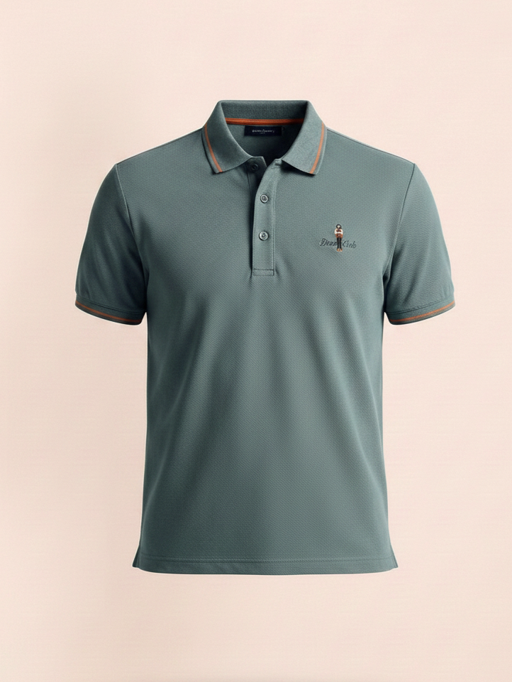 Green polo shirt with a small logo on a beige background