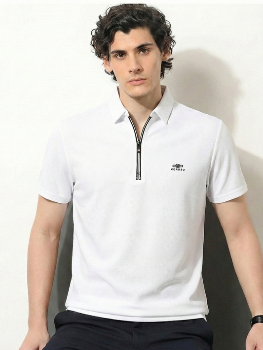 Man wearing a white polo shirt with a zipper and logo on a neutral background
