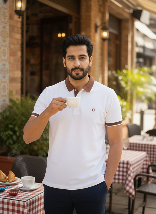 Man holding a cup outdoors in a casual setting