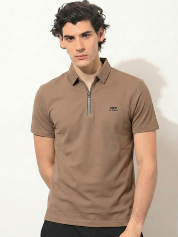 Man wearing a brown polo shirt with a small logo on a white background