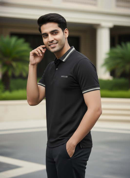 Man wearing a black polo tshirt with a blurred background