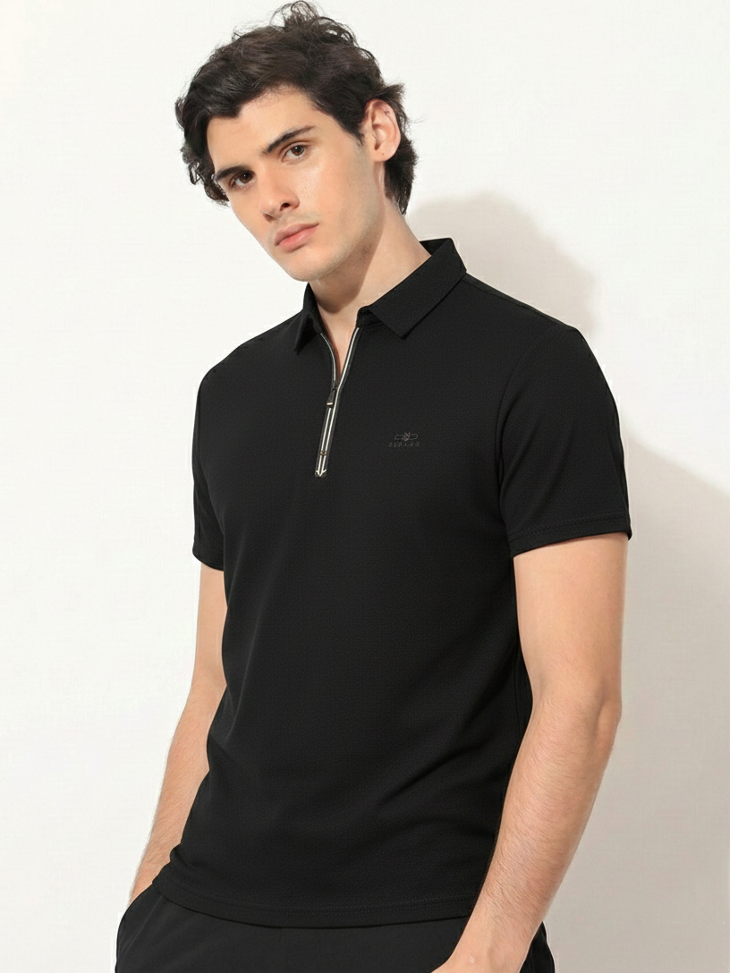 Man wearing a black polo shirt with a zipper on a white background