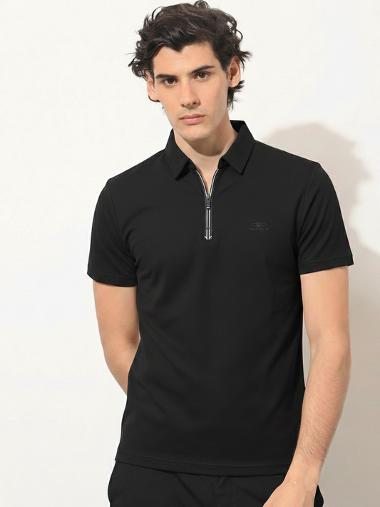 Man wearing a black polo shirt with a small logo on a white background