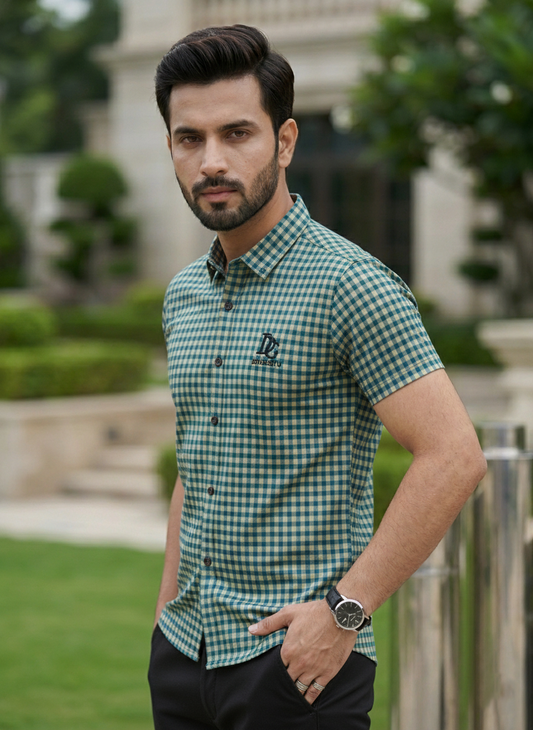 Man wearing a green and white checkered shirt outdoors