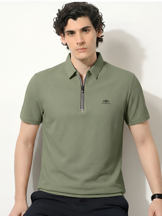 Man wearing a green polo shirt with a zipper against a white background