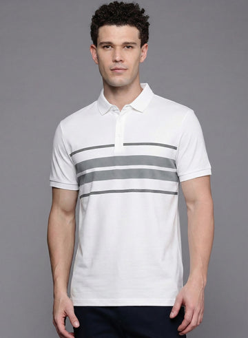 Man wearing a white polo shirt with gray stripes on a gray background