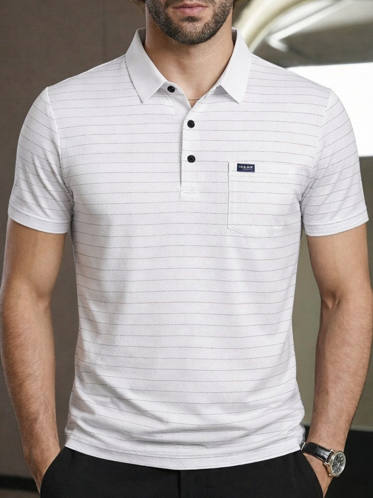 Man wearing a white striped polo shirt with a brand logo, standing indoors.