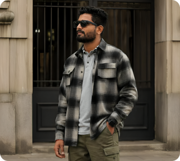 Man wearing a black and grey checkered overshirt with sunglasses
