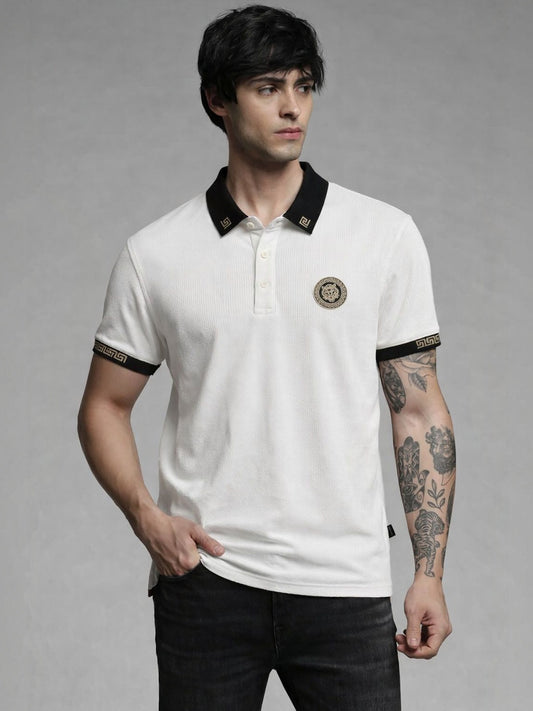 Man wearing a white polo shirt with black accents and a logo on a gray background