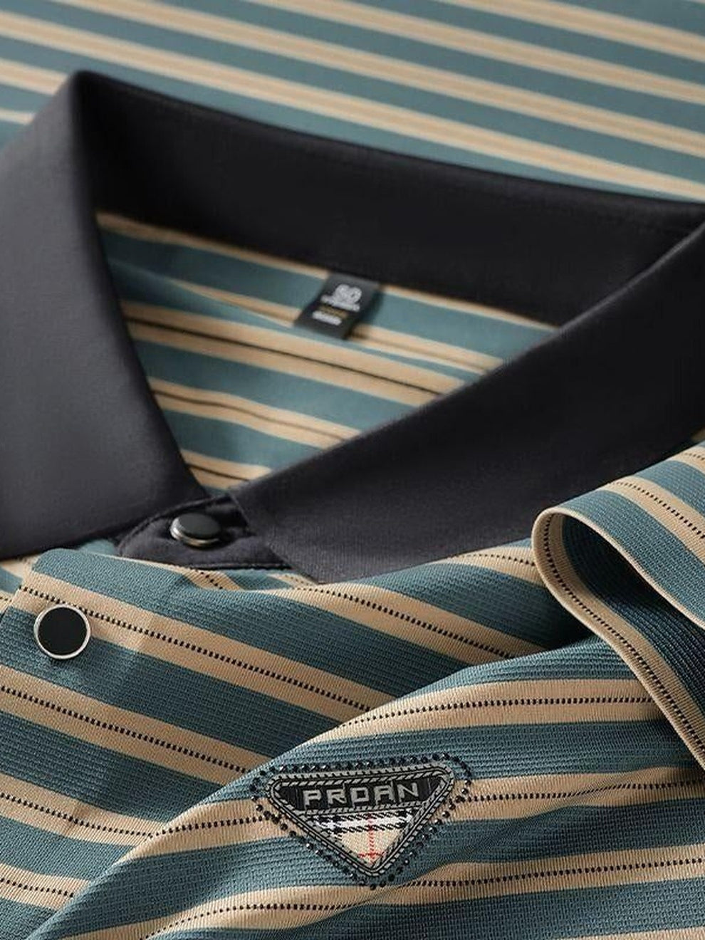 Close-up of a striped shirt with Prada label on a striped background