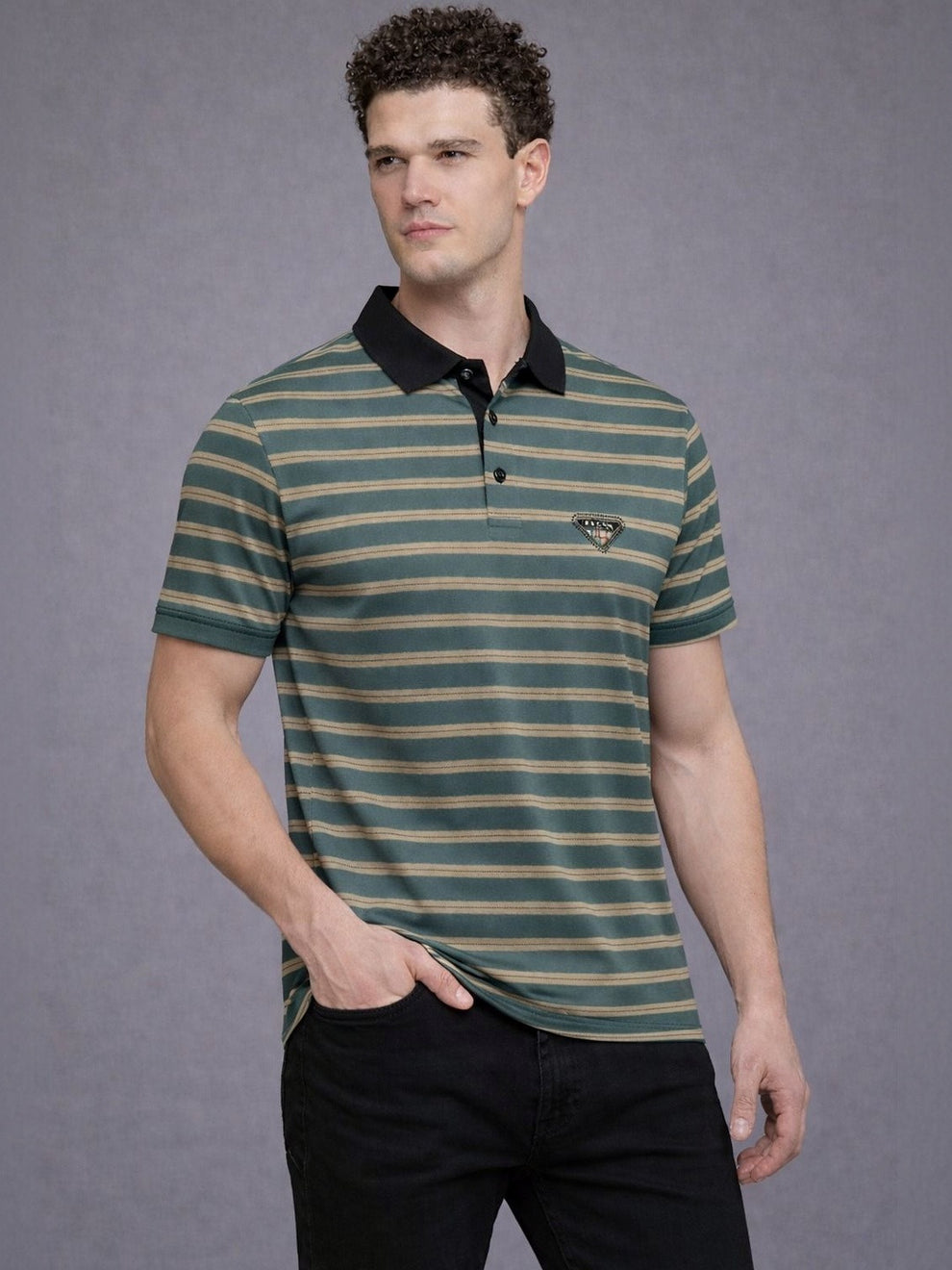 Man wearing a green and black striped polo shirt against a gray background
