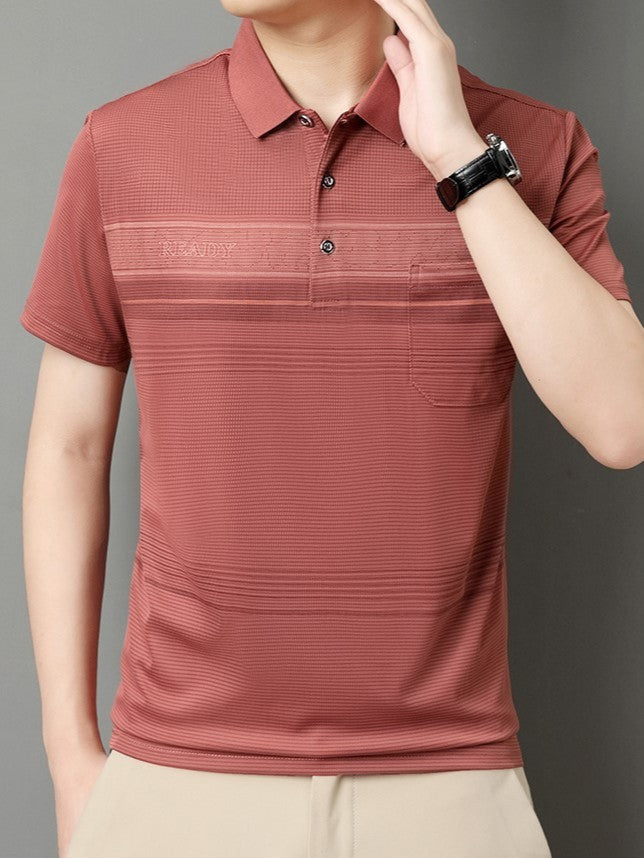Person wearing a red striped polo shirt against a gray background