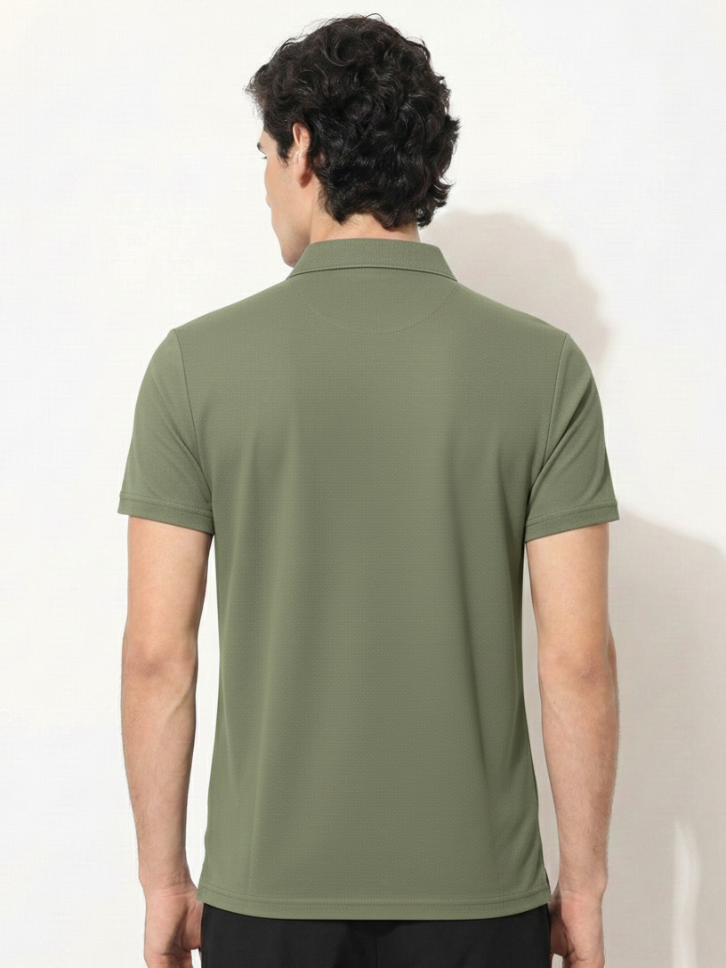 Person wearing a green polo shirt against a white background