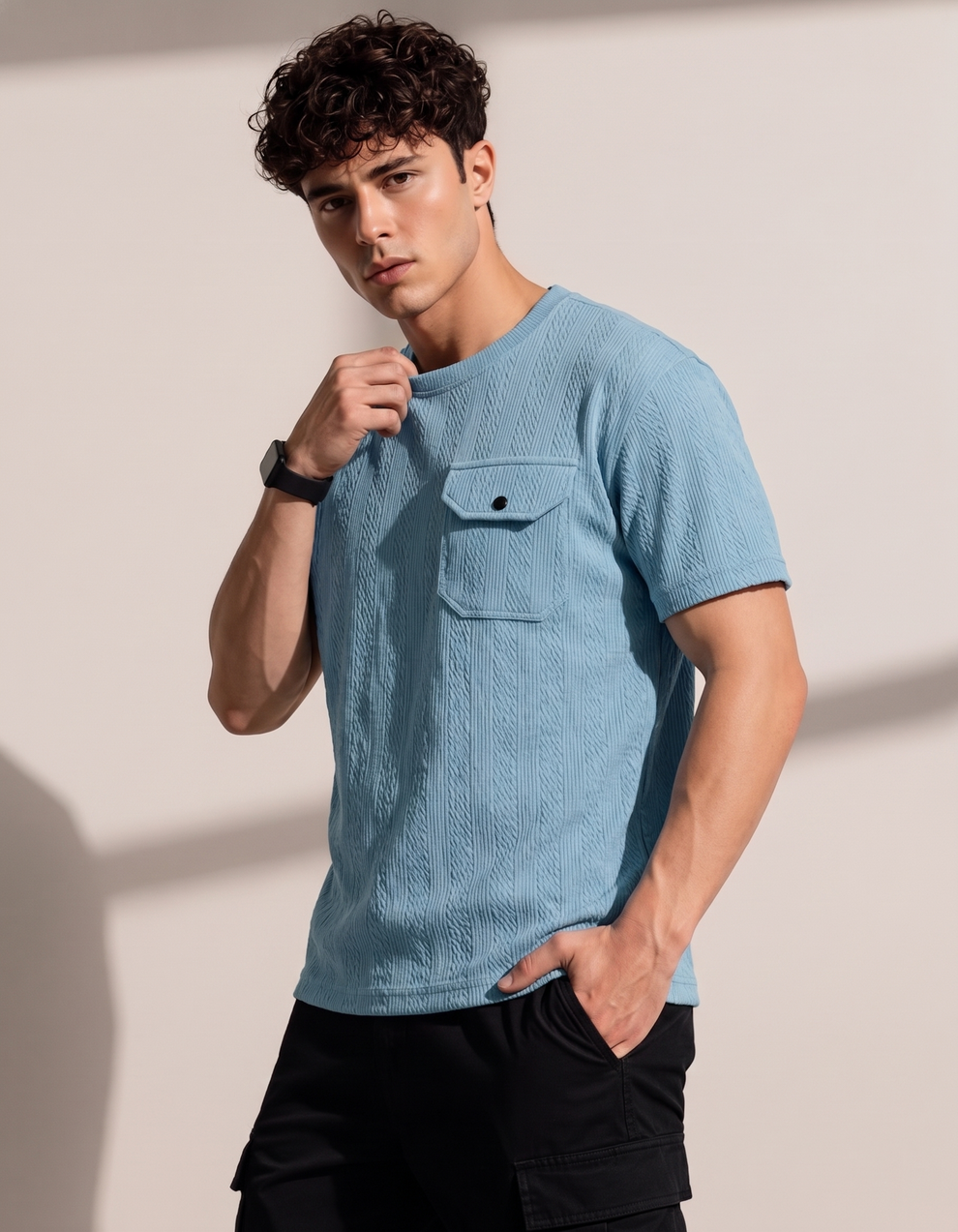 Man wearing a textured blue shirt against a plain background