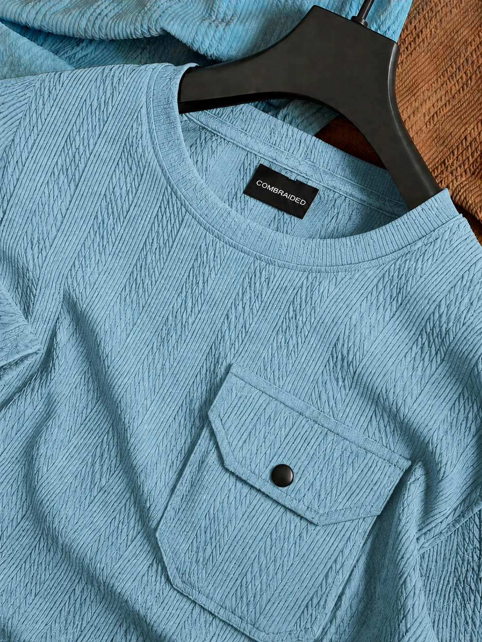 Blue textured shirt with a brand label on a hanger