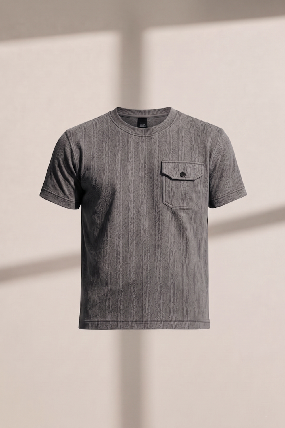 Gray t-shirt with a pocket on a beige background