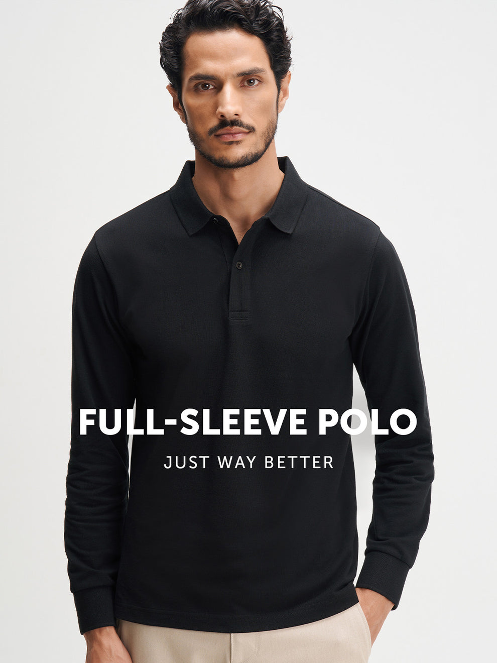 Man wearing a black full-sleeve polo shirt with promotional text on a light gray background