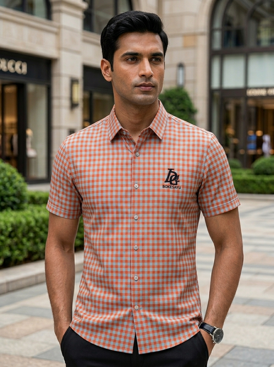 Man wearing a checkered shirt with a brand logo in an urban setting