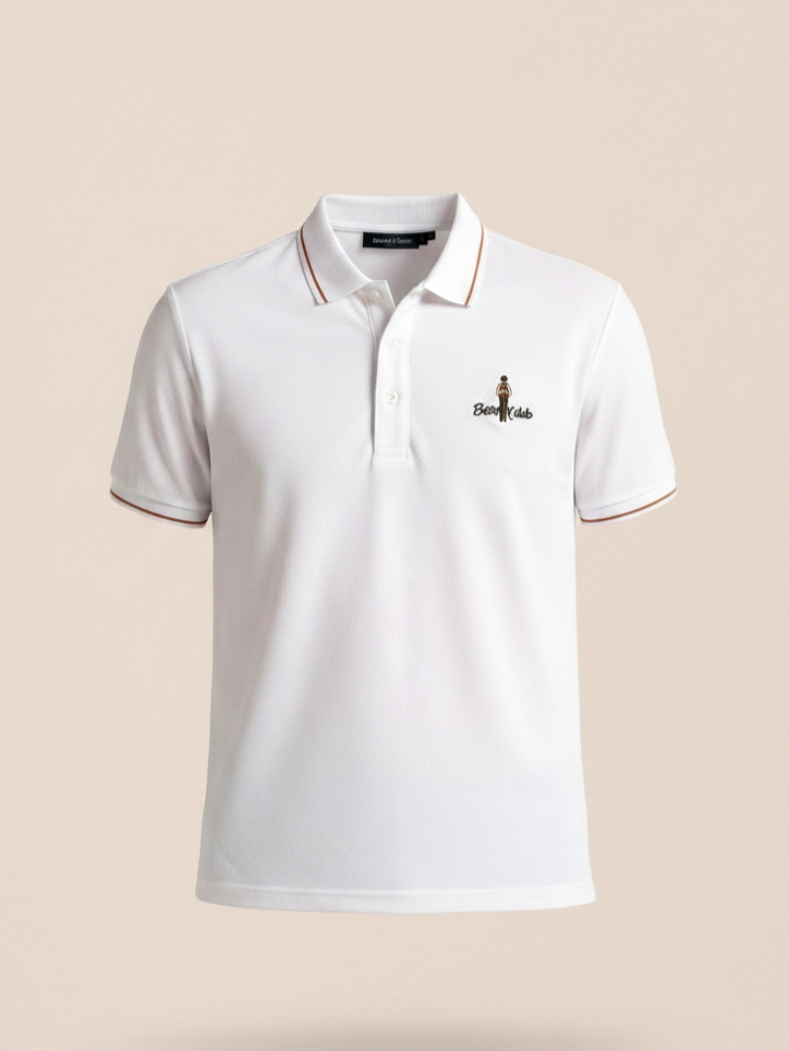 White polo shirt with a small logo on a beige background