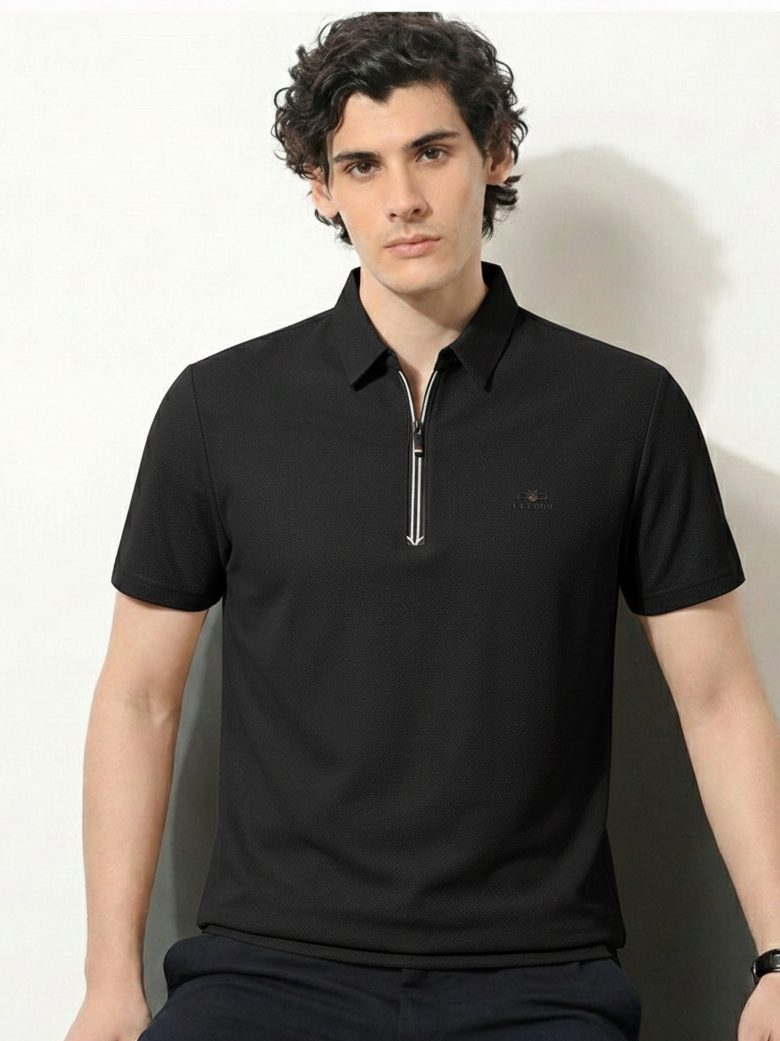 Man wearing a black polo shirt with a zipper on a white background