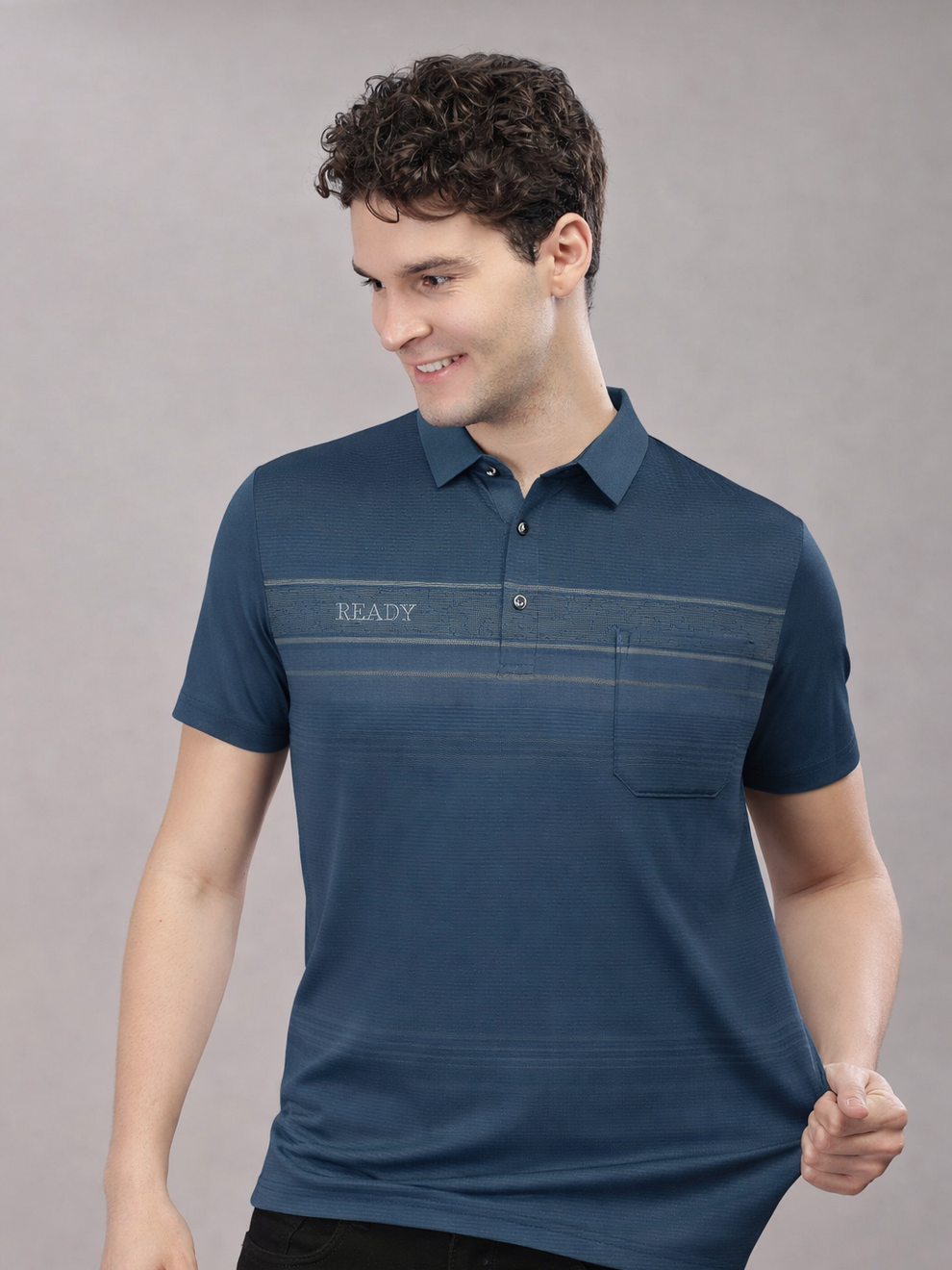 Man wearing a blue polo shirt with 'READY' text on a gray background