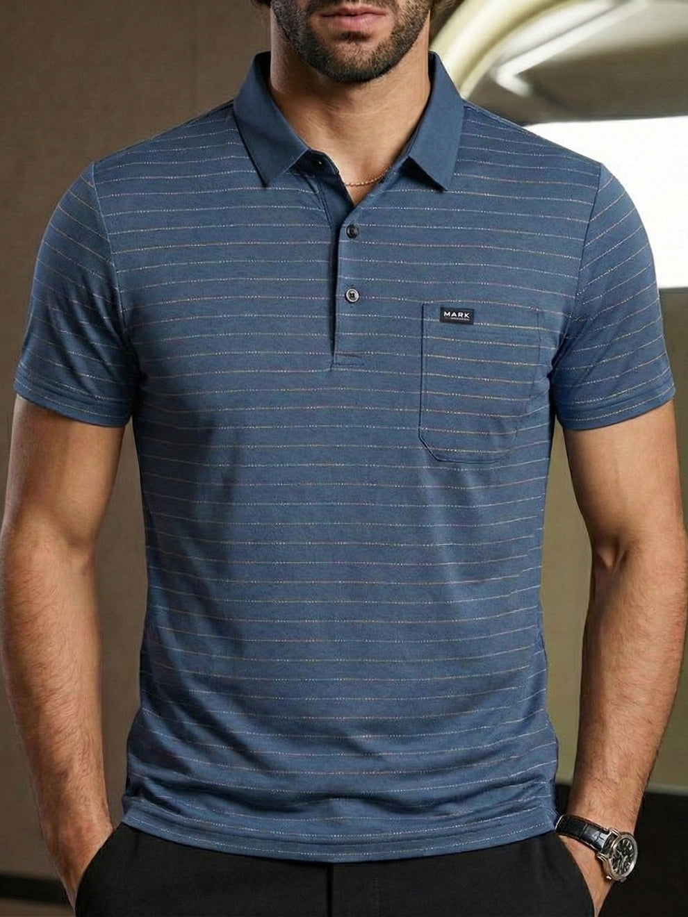 Man wearing a blue striped polo shirt with a visible brand logo.