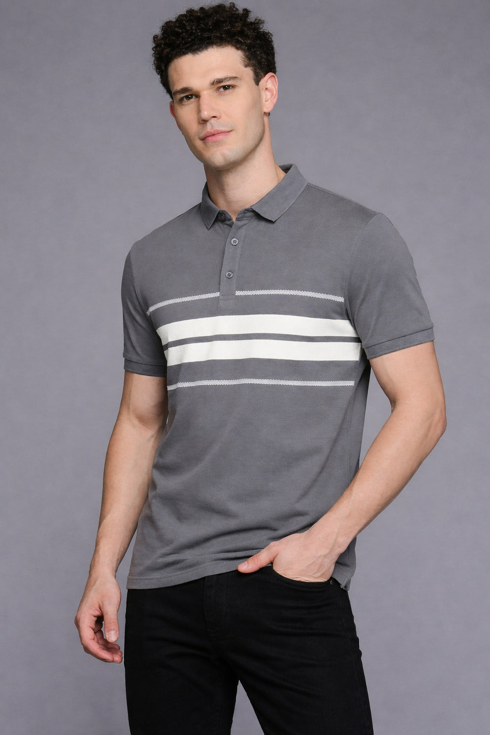 Man wearing a gray polo shirt with white stripes on a gray background
