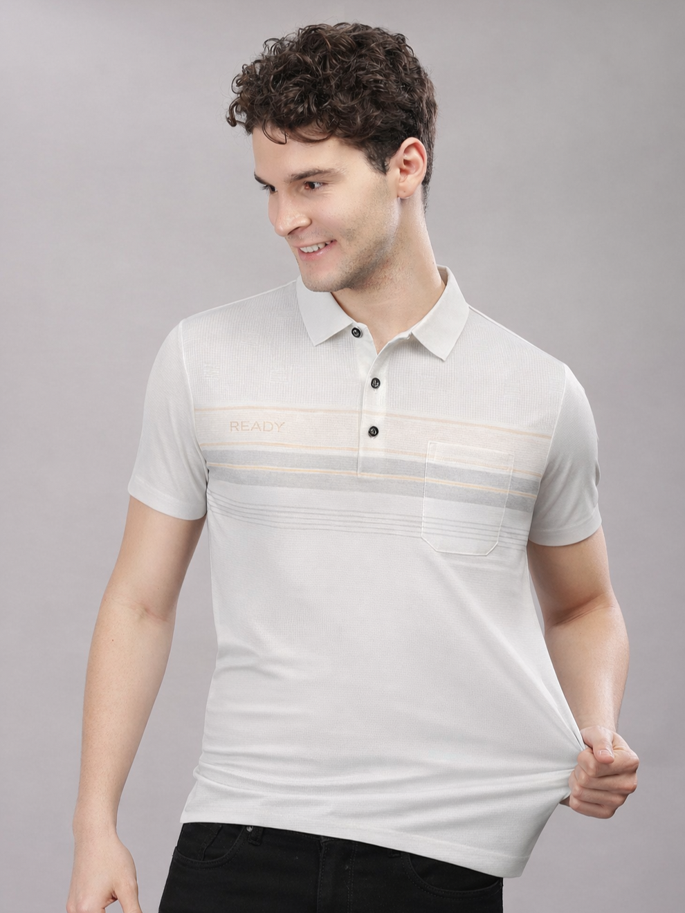 Man wearing a light gray polo shirt with subtle pattern on a gray background