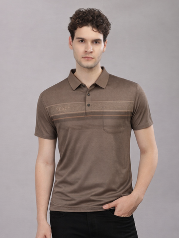Man wearing a brown polo shirt against a gray background