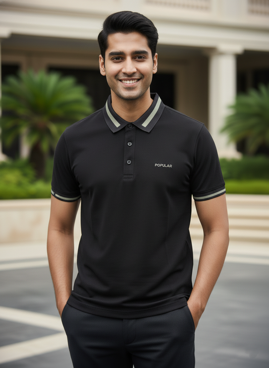 Man wearing a black polo shirt with 'Poplar' branding outdoors.