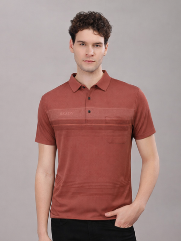 Man wearing a red polo tshirt against a gray background