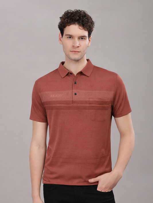 Man wearing a red polo tshirt against a gray background
