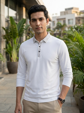 Man wearing a white long-sleeve shirt with a patterned collar in an outdoor setting.
