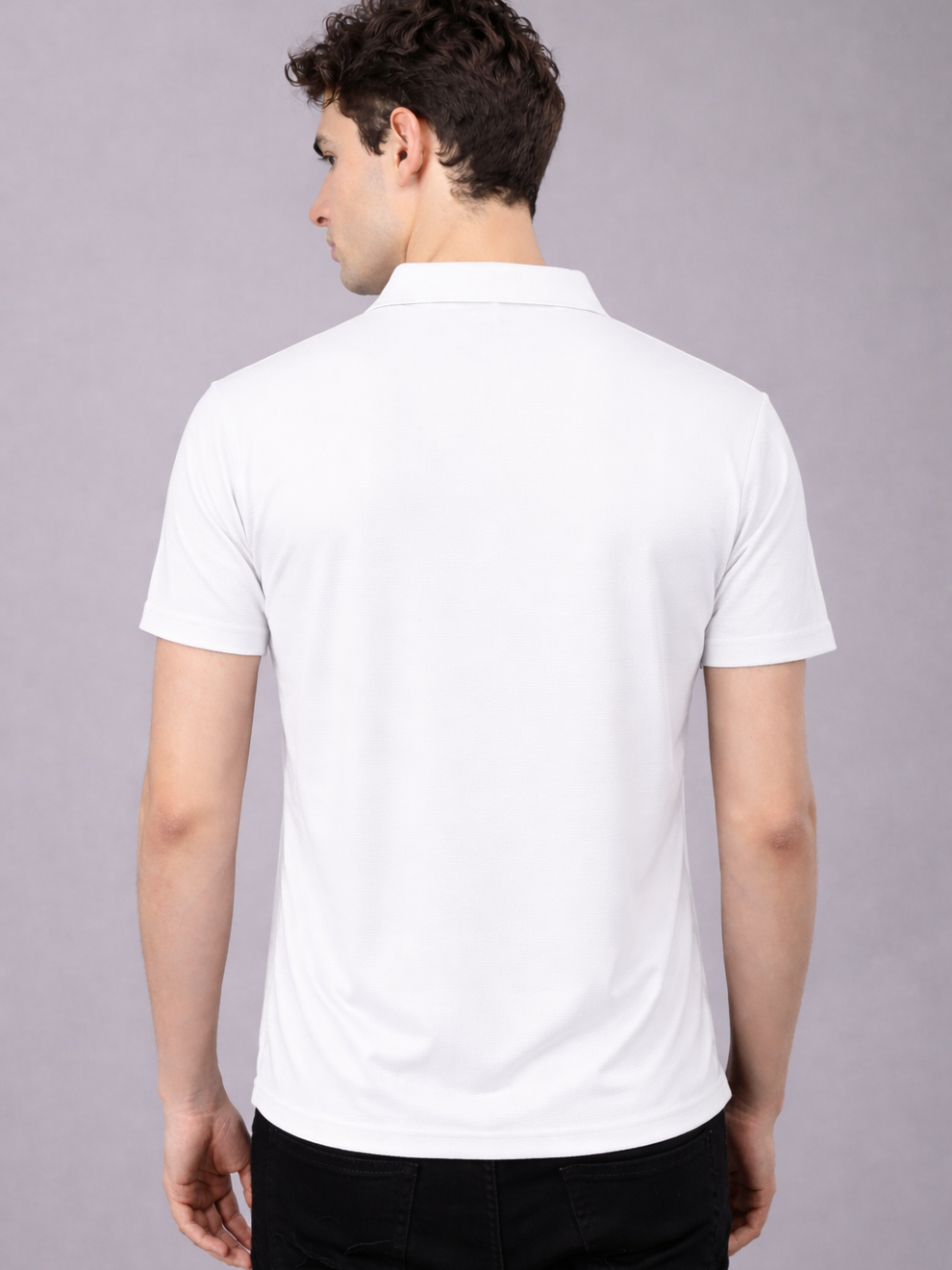 Person wearing a white polo shirt on a gray background